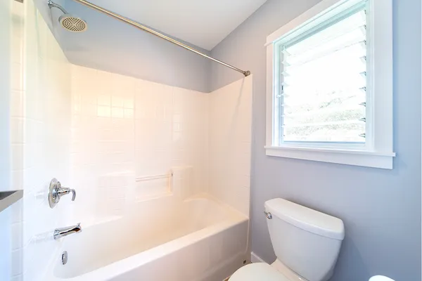 a bathroom with a toilet and a bathtub
