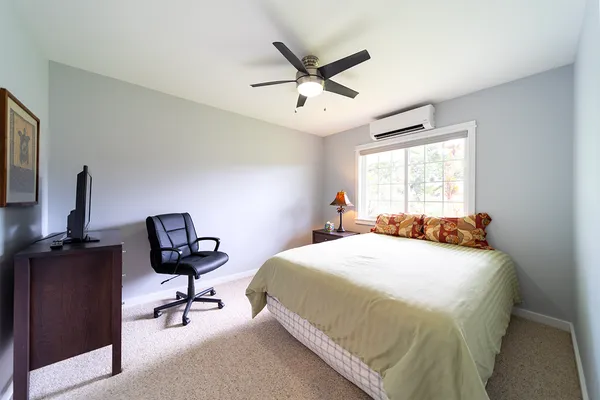 a bedroom with a bed and a desk