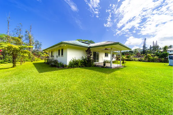 a view of an house with backyard space and garden