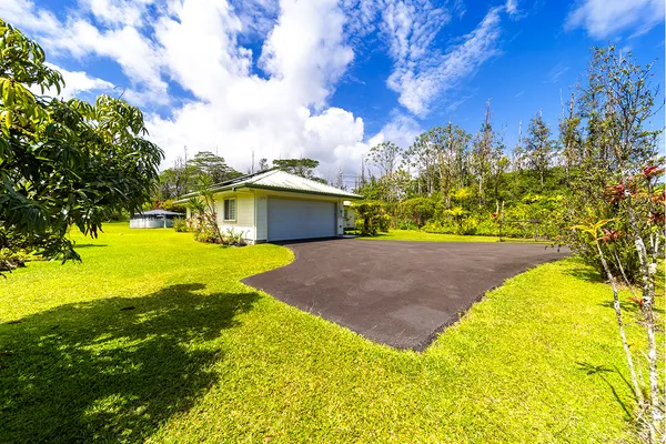a aerial view of a house with swimming pool table and chairs