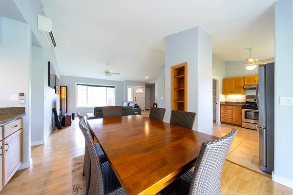 a dining room with furniture and wooden floor