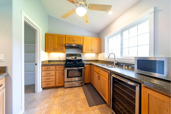 a kitchen with stainless steel appliances a stove sink and microwave