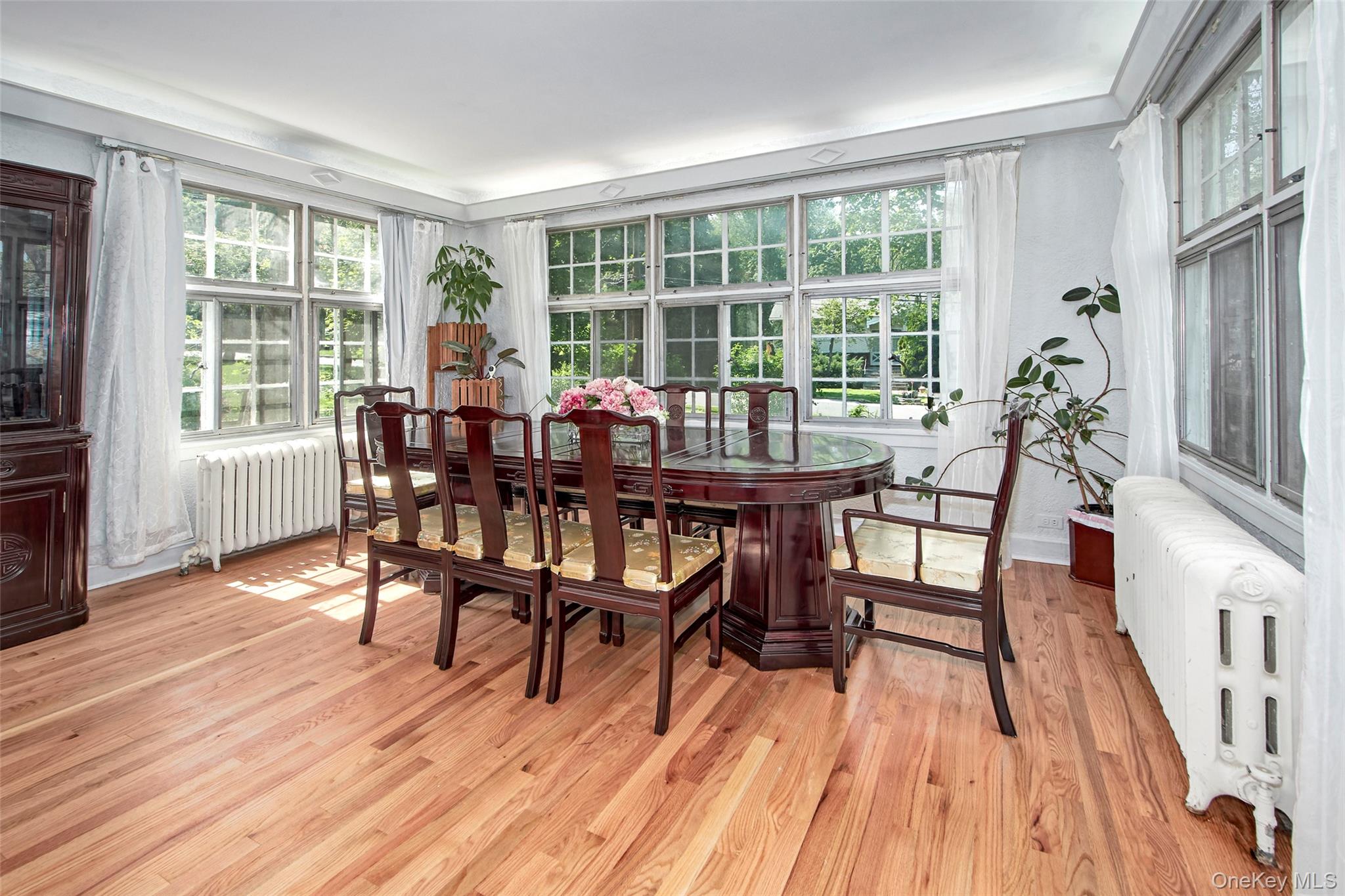 2 Byworth Road New Rochelle, NY 10804 - Photo 9 of 31 Dining space featuring radiator heating unit, healthy amount of natural light, and light wood-style floors
