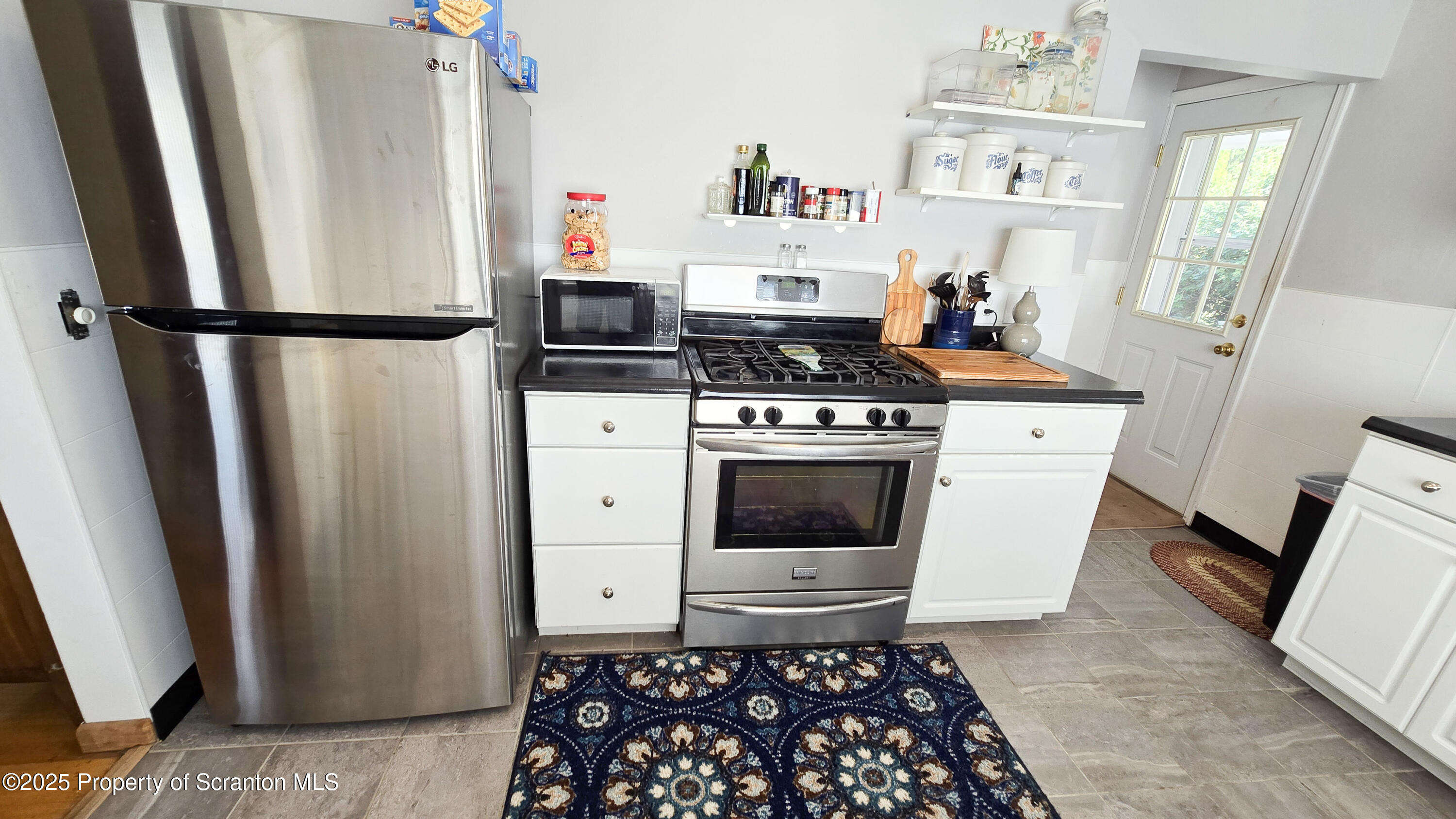 205 Carter Street Old Forge, PA 18518 - Photo 11 of 25 a kitchen with stainless steel appliances a stove a refrigerator and cabinets