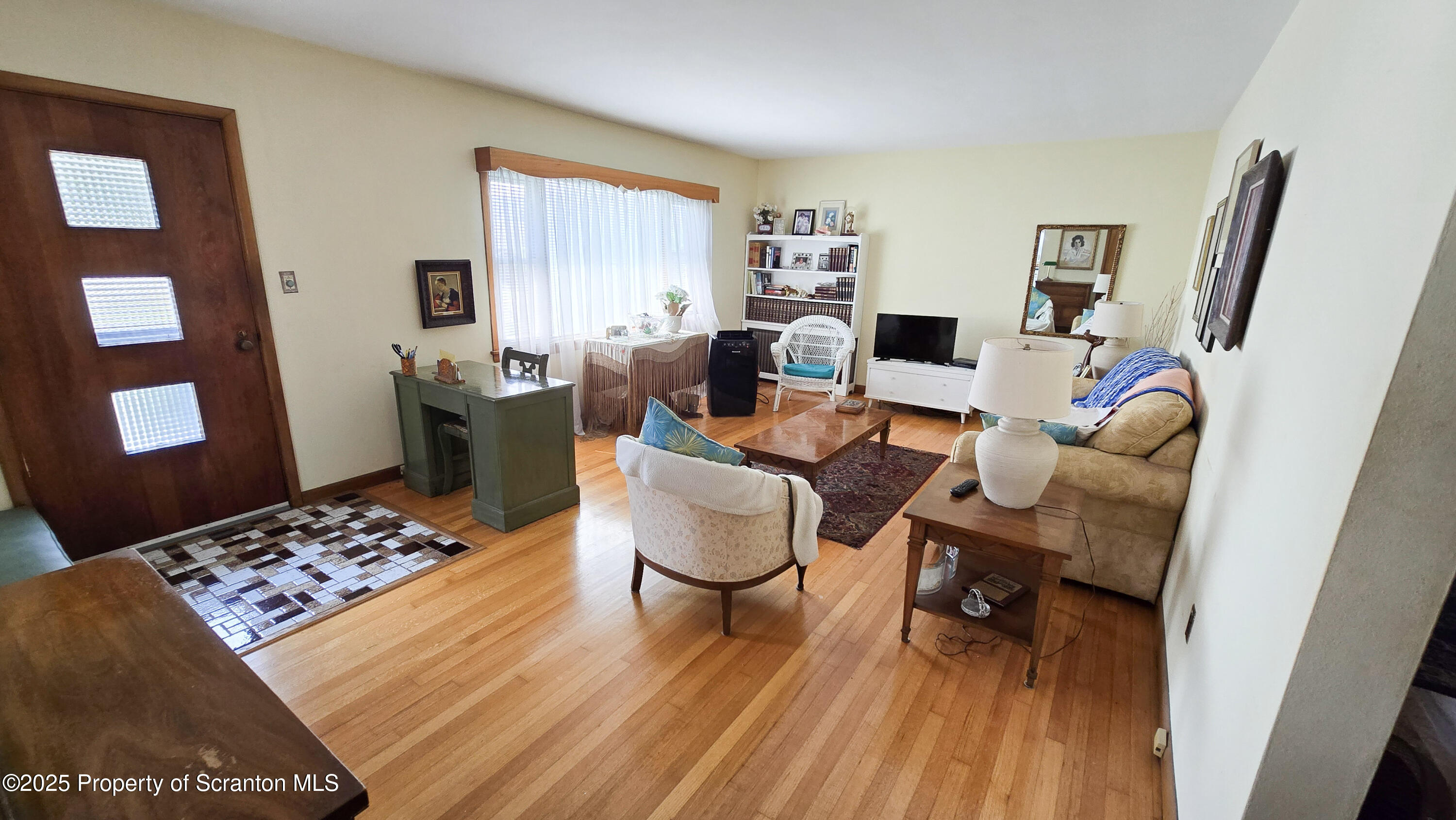 205 Carter Street Old Forge, PA 18518 - Photo 6 of 25 a living room with furniture a rug and a flat screen tv