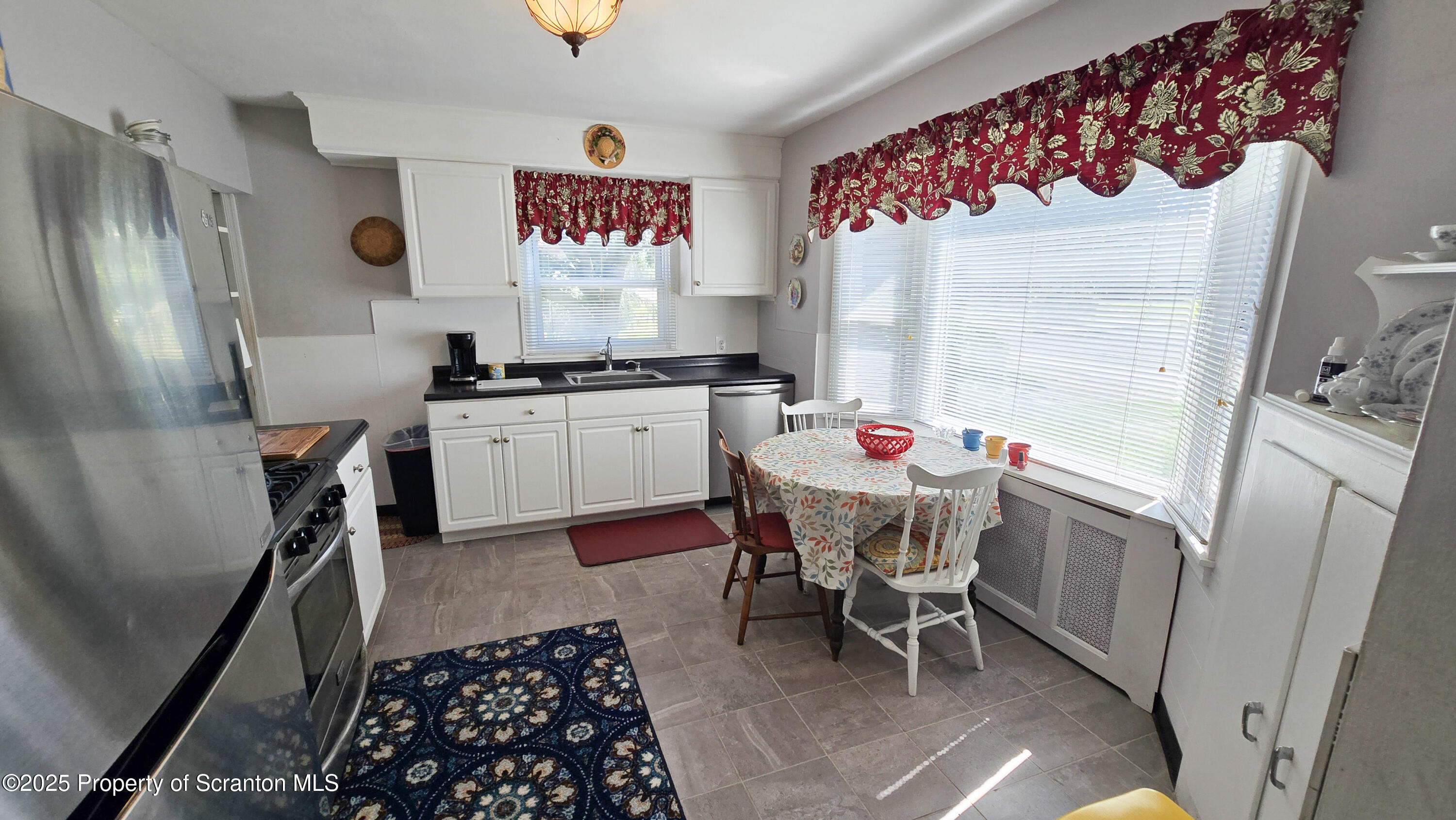 205 Carter Street Old Forge, PA 18518 - Photo 9 of 25 a very nice looking dining room with a dining table and a refrigerator
