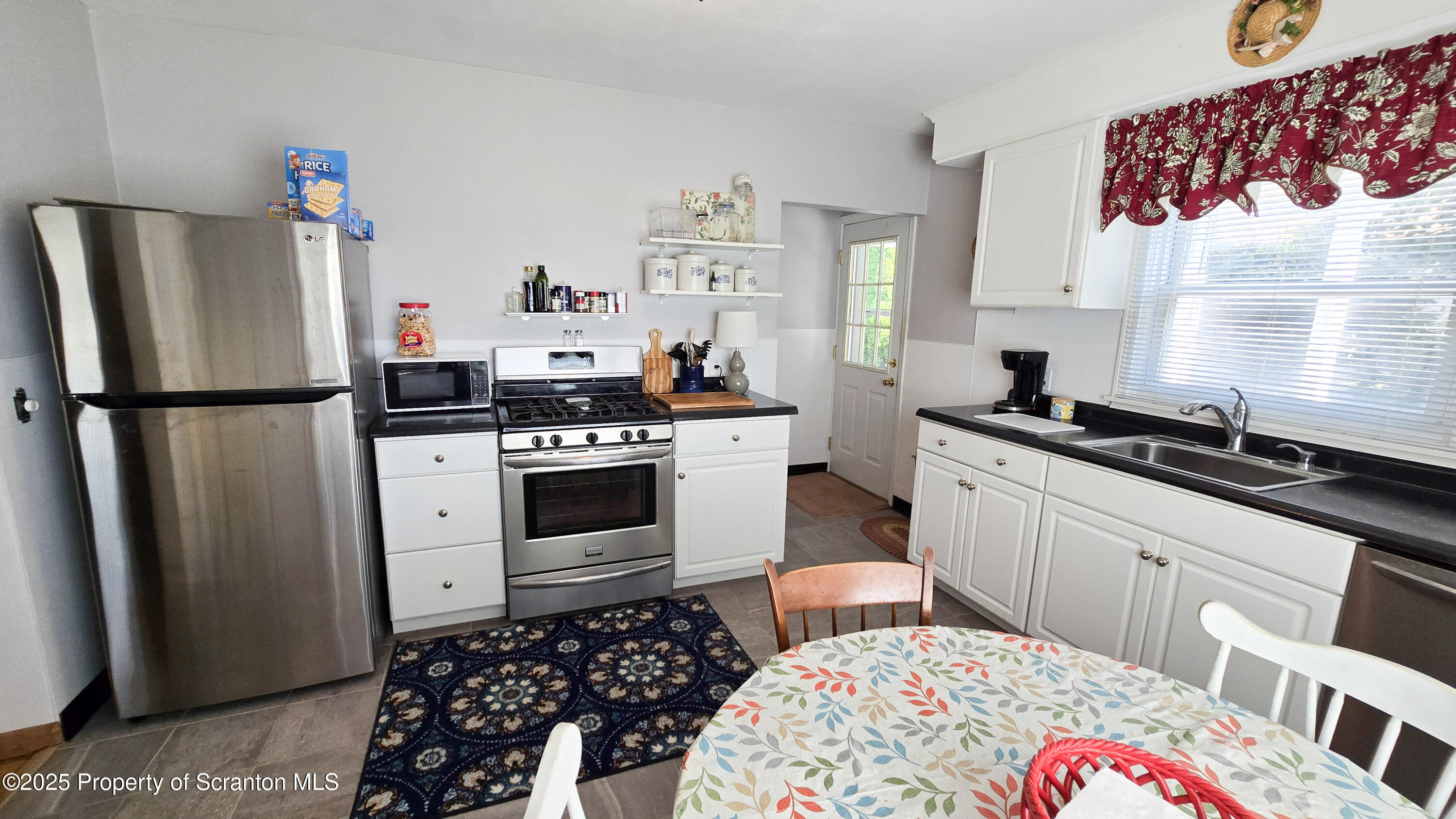 205 Carter Street Old Forge, PA 18518 - Photo 10 of 25 a kitchen with stainless steel appliances a refrigerator sink and stove