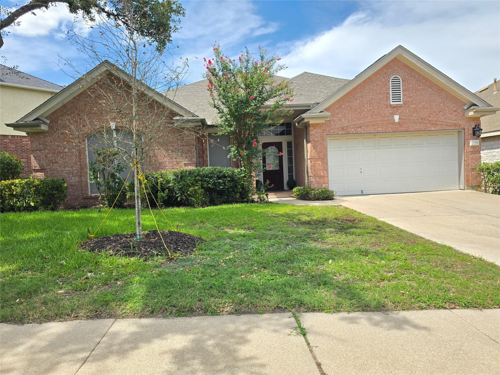 2216 Shark Loop Round Rock, TX 78664 - Photo 1 of 27 a front view of a house with garden