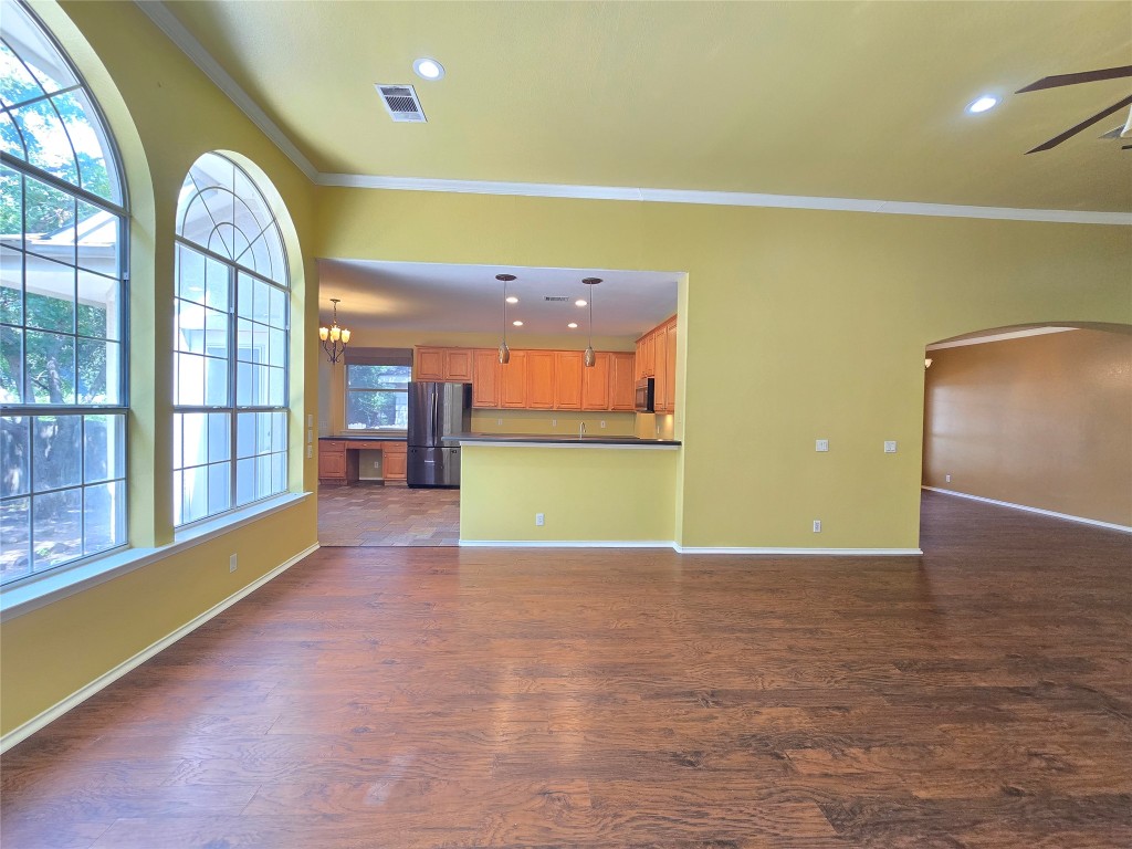 2216 Shark Loop Round Rock, TX 78664 - Photo 12 of 27 a view of a room with wooden floor and windows