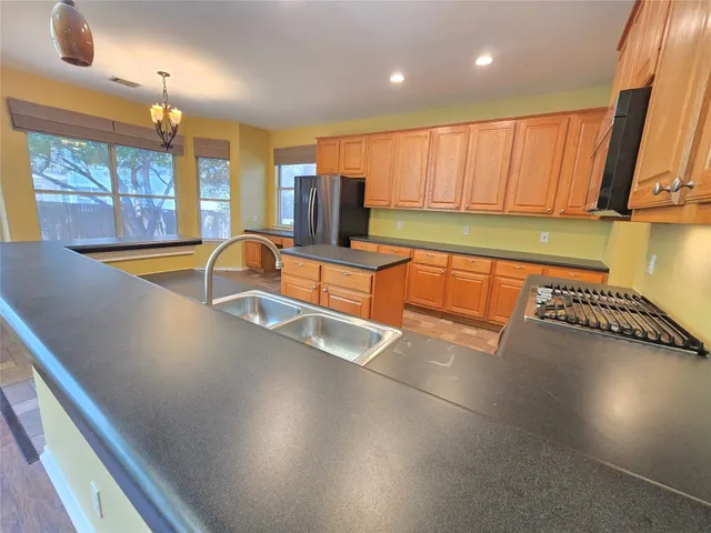 a view of a kitchen with a large window and furniture