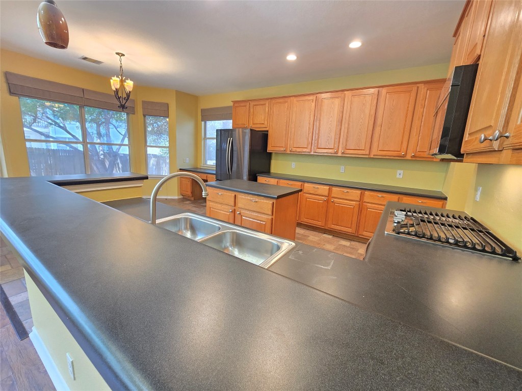 2216 Shark Loop Round Rock, TX 78664 - Photo 13 of 27 a view of a kitchen with a large window and furniture