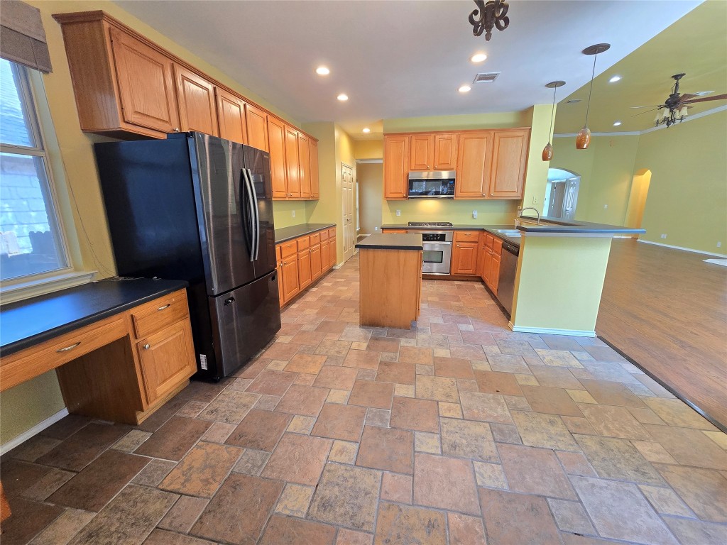 2216 Shark Loop Round Rock, TX 78664 - Photo 14 of 27 a kitchen with stainless steel appliances a refrigerator and a stove