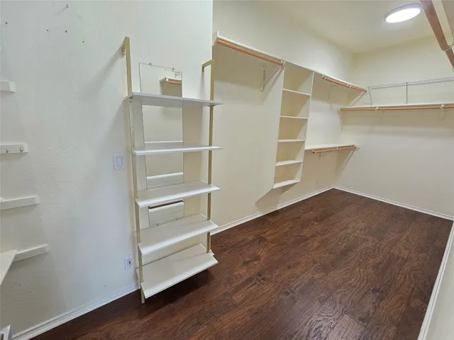 a view of walk in closet with empty racks