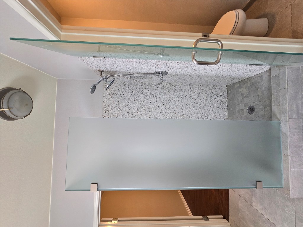 2216 Shark Loop Round Rock, TX 78664 - Photo 19 of 27 a bathroom with a granite countertop shower and a toilet