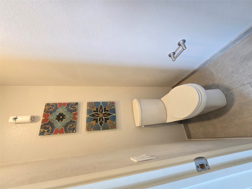 2216 Shark Loop Round Rock, TX 78664 - Photo 20 of 27 a white toilet sitting next to a shower