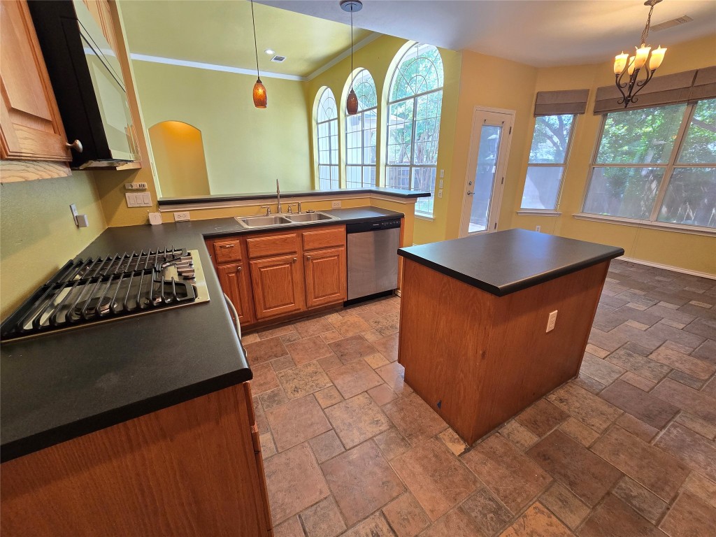 2216 Shark Loop Round Rock, TX 78664 - Photo 26 of 27 a kitchen with stainless steel appliances granite countertop a sink a stove and a refrigerator