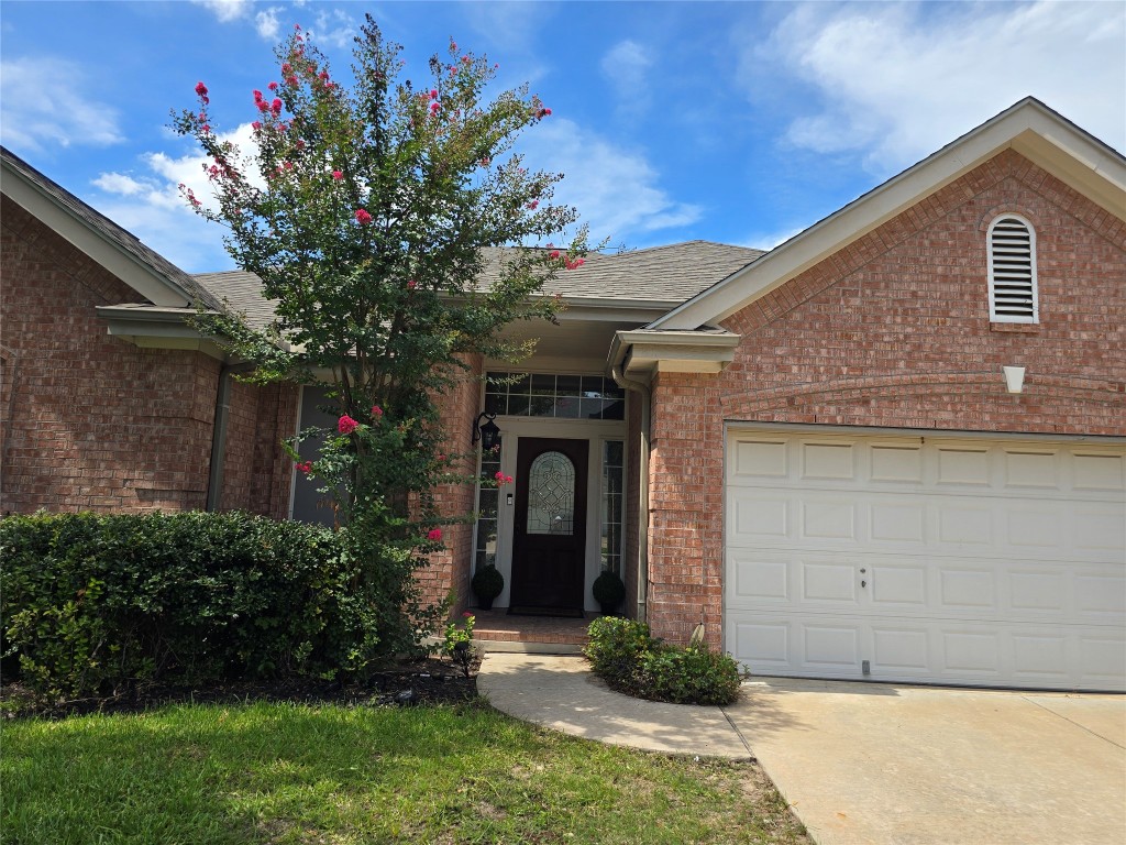 2216 Shark Loop Round Rock, TX 78664 - Photo 3 of 27 a front view of a house with garden