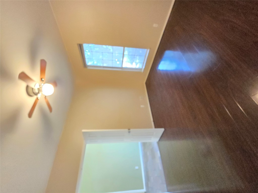 2216 Shark Loop Round Rock, TX 78664 - Photo 5 of 27 a view of an empty room with wooden floor and a window