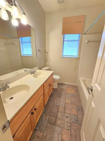 a bathroom with a sink a toilet and mirror