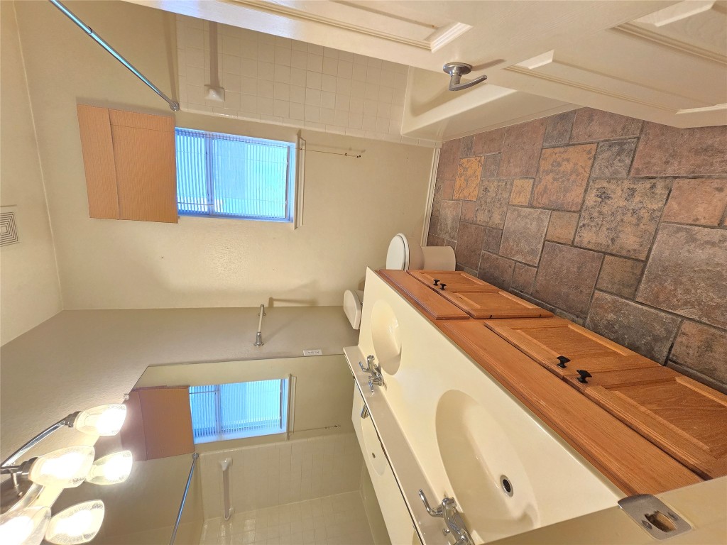 2216 Shark Loop Round Rock, TX 78664 - Photo 6 of 27 a bathroom with a sink a toilet and mirror