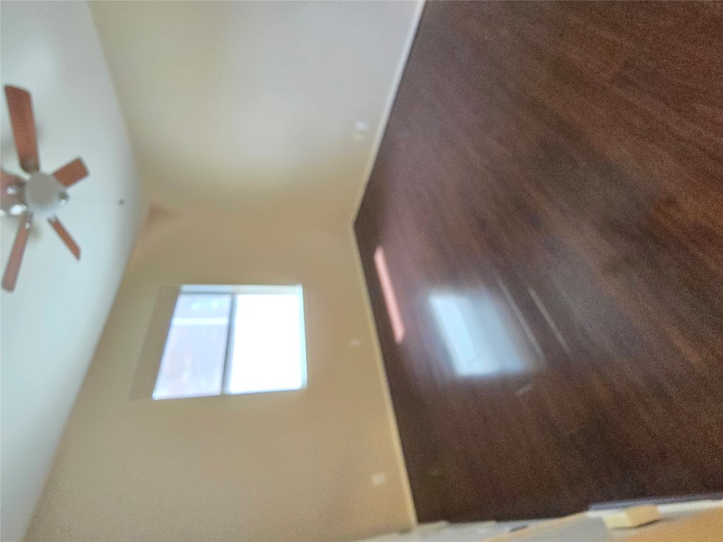 2216 Shark Loop Round Rock, TX 78664 - Photo 8 of 27 an empty room with a ceiling fan and windows