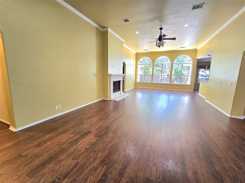 2216 Shark Loop Round Rock, TX 78664 - Photo 9 of 27 wooden floor in an empty room with a window