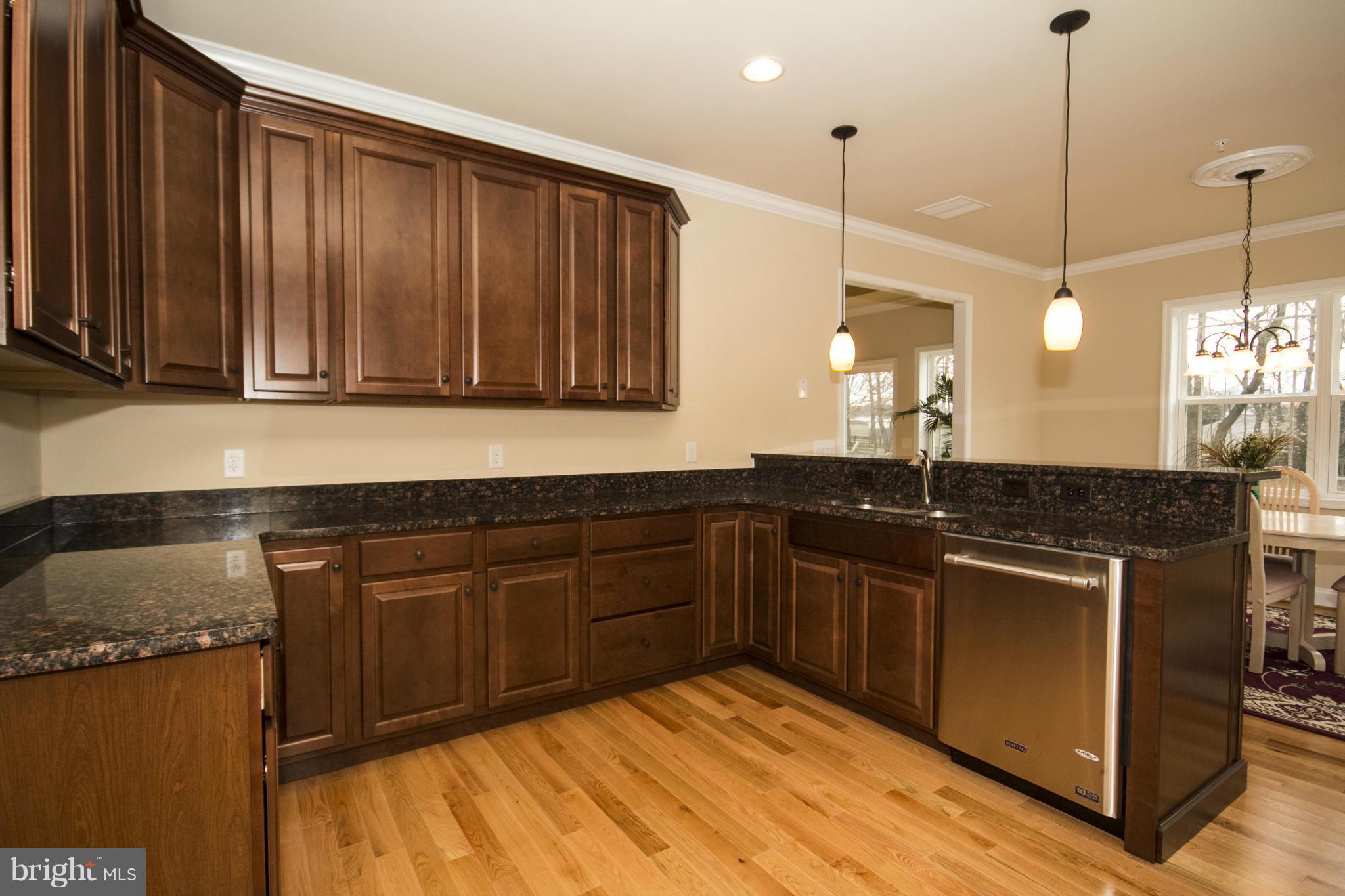 254 Nanticoke Road Baltimore, MD 21221 - Photo 13 of 30 a kitchen with stainless steel appliances granite countertop a sink a stove and a wooden cabinets