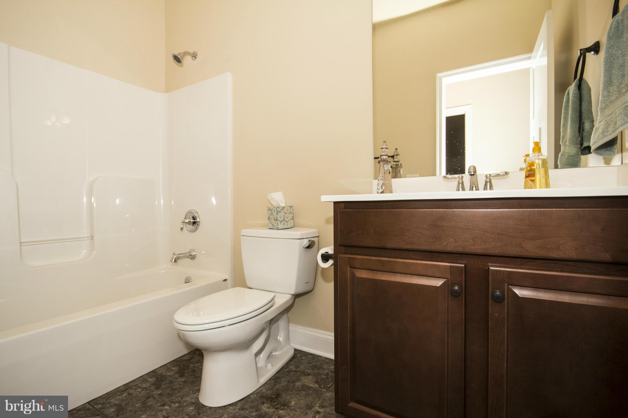 254 Nanticoke Road Baltimore, MD 21221 - Photo 27 of 30 a bathroom with a sink a toilet and a mirror