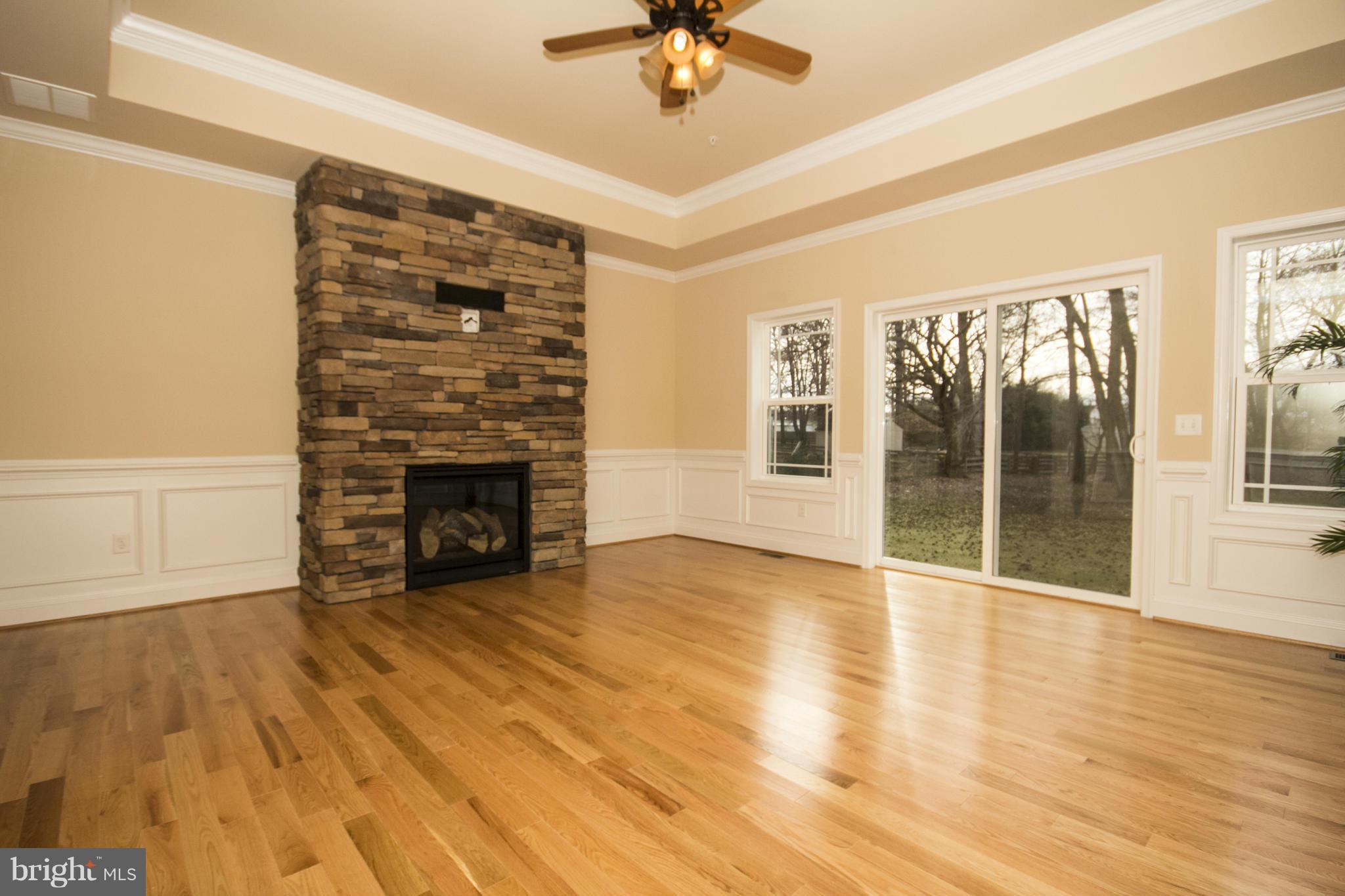 254 Nanticoke Road Baltimore, MD 21221 - Photo 7 of 30 a view of an empty room with a window and wooden floor