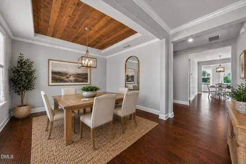 a view of a room with wooden floor and a ceiling fan