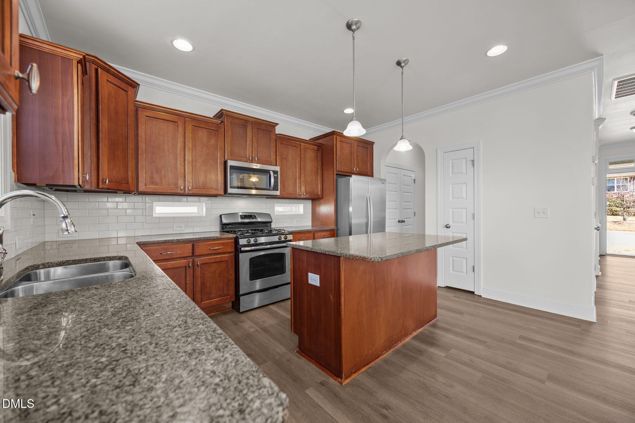 336 Plott Hound Lane Wake Forest, NC 27587 - Photo 11 of 39 a kitchen with stainless steel appliances granite countertop a stove a sink dishwasher a refrigerator and a oven with wooden floor