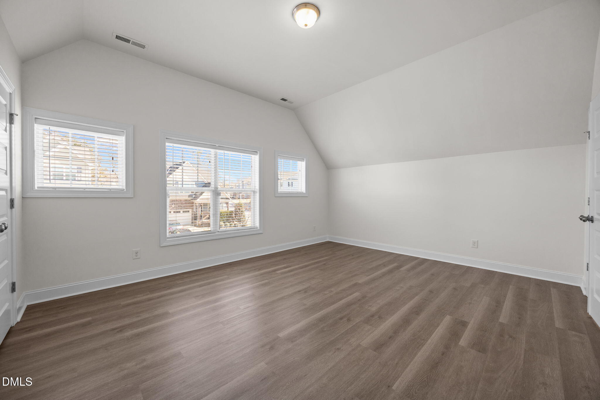 336 Plott Hound Lane Wake Forest, NC 27587 - Photo 20 of 39 an empty room with wooden floor and windows