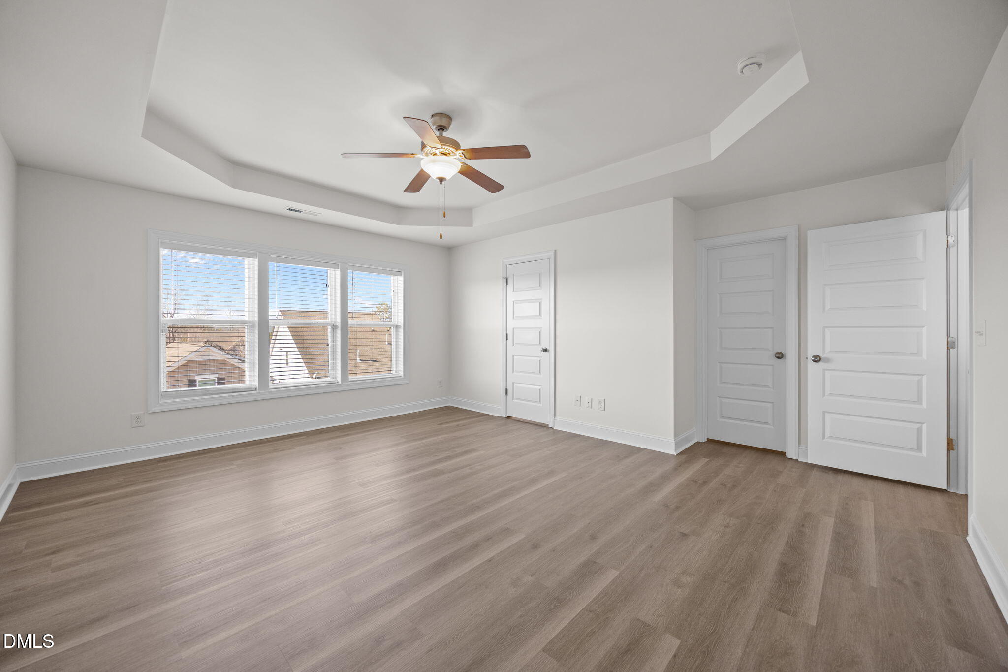 336 Plott Hound Lane Wake Forest, NC 27587 - Photo 22 of 39 an empty room with wooden floor chandelier fan and windows