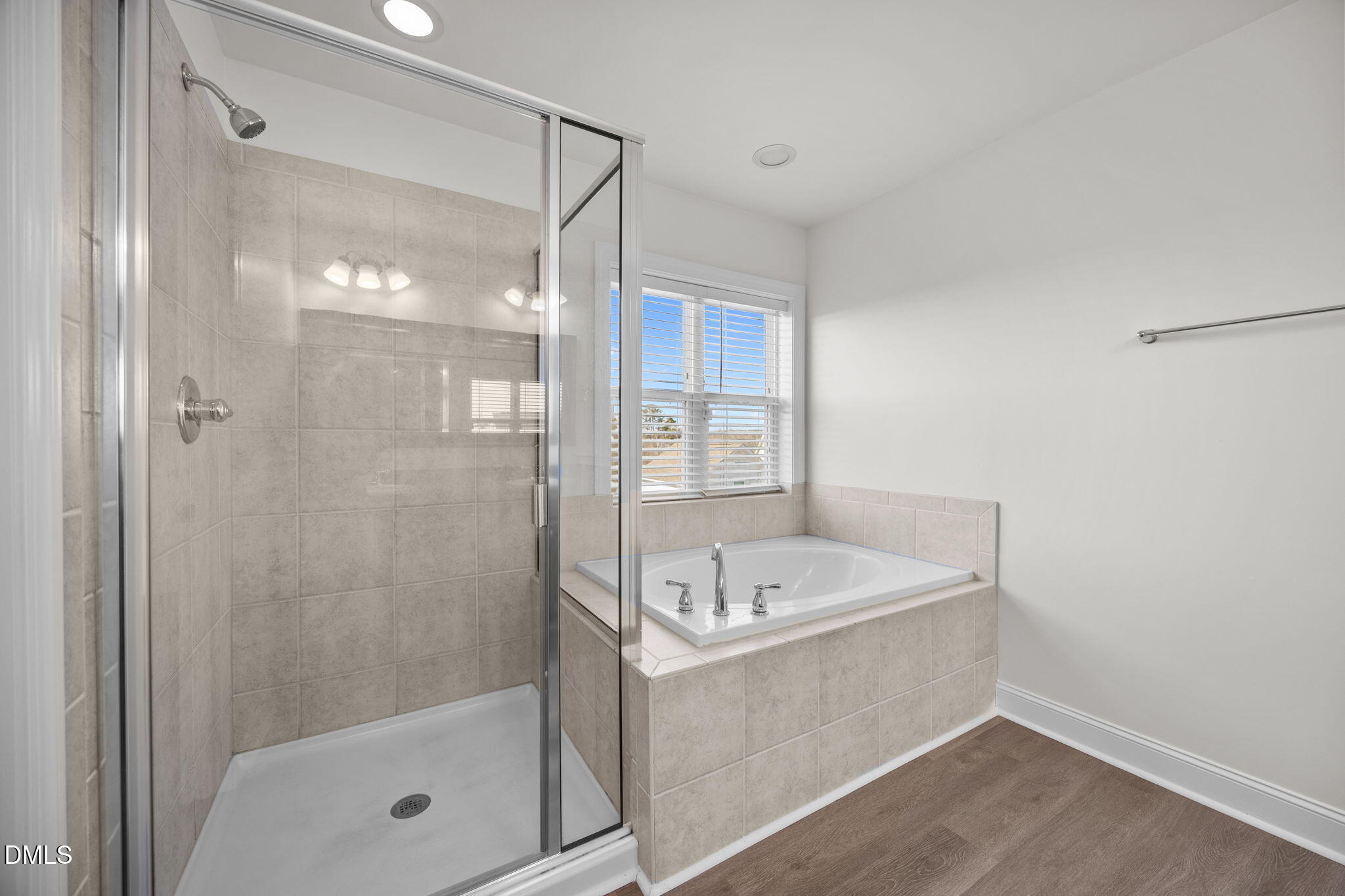 336 Plott Hound Lane Wake Forest, NC 27587 - Photo 24 of 39 a bathroom with a tub sink shower and mirror