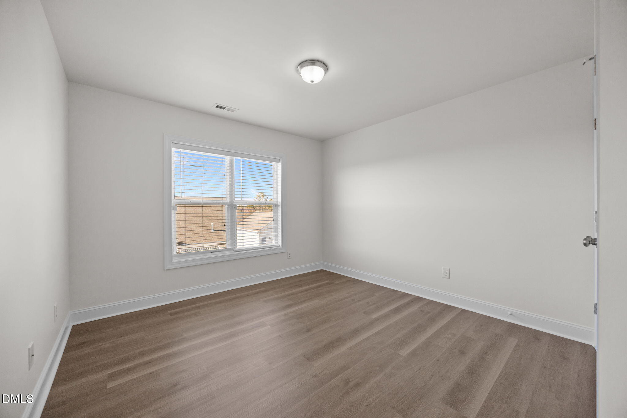 336 Plott Hound Lane Wake Forest, NC 27587 - Photo 27 of 39 an empty room with wooden floor and windows