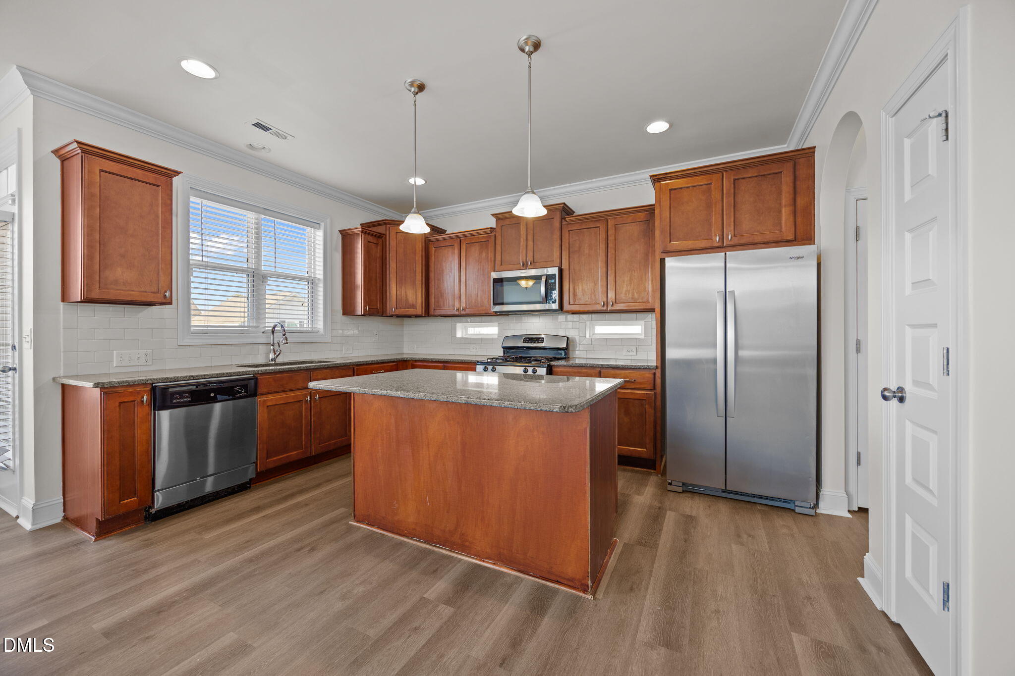 336 Plott Hound Lane Wake Forest, NC 27587 - Photo 6 of 39 a kitchen with stainless steel appliances granite countertop a refrigerator a sink dishwasher a stove with wooden cabinets and floor