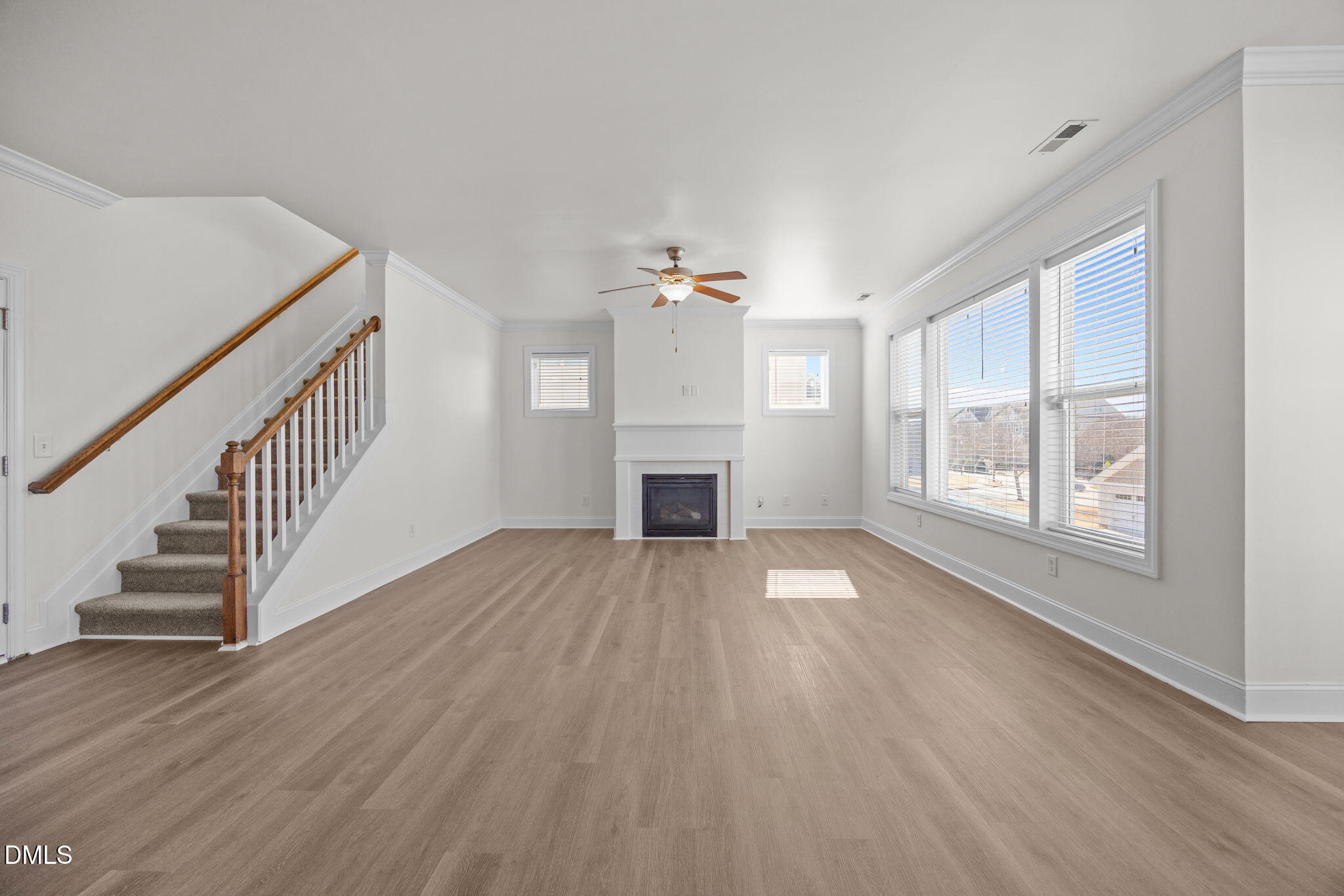 336 Plott Hound Lane Wake Forest, NC 27587 - Photo 7 of 39 a view of an empty room with wooden floor and a window