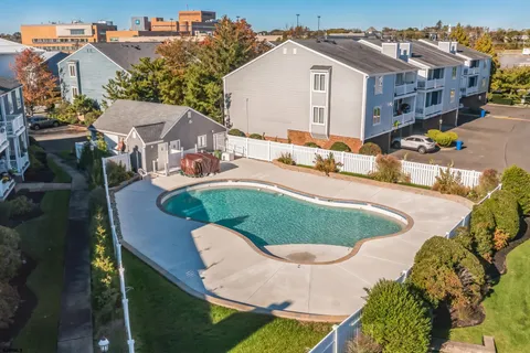 an aerial view of a house with swimming pool and patio