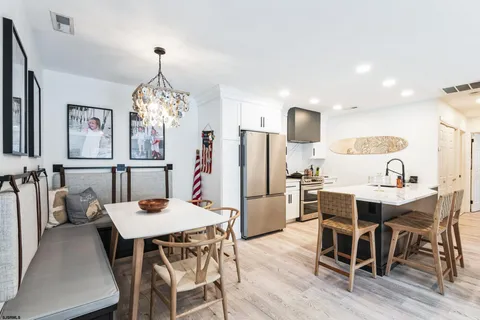 a view of a dining room with furniture and chandelier