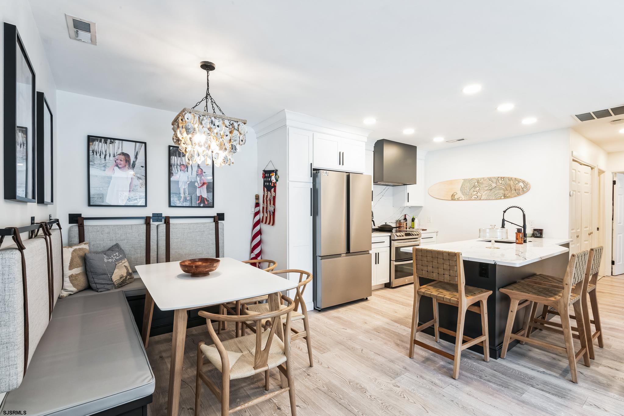 308 Harbour Cove, Unit 308 Somers Point, NJ 08244 - Photo 5 of 16 a view of a dining room with furniture and chandelier