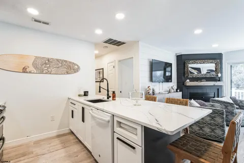 a kitchen with a stove a sink and a refrigerator