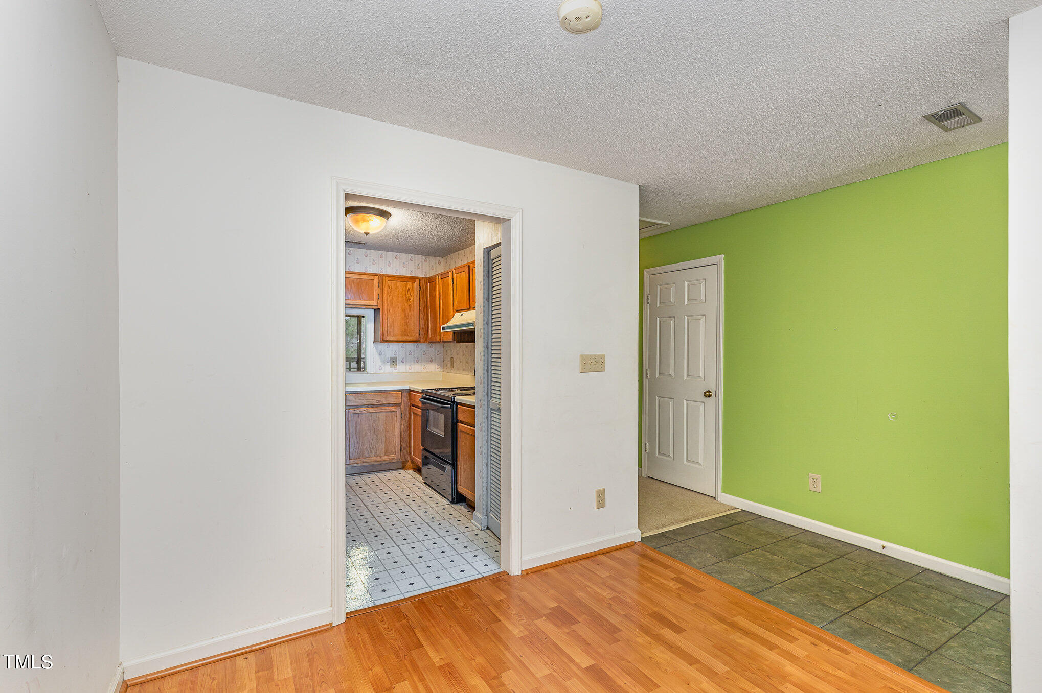 4631 Timbermill Court, Unit 303 Raleigh, NC 27612 - Photo 5 of 15 a view of a kitchen with a sink and a refrigerator