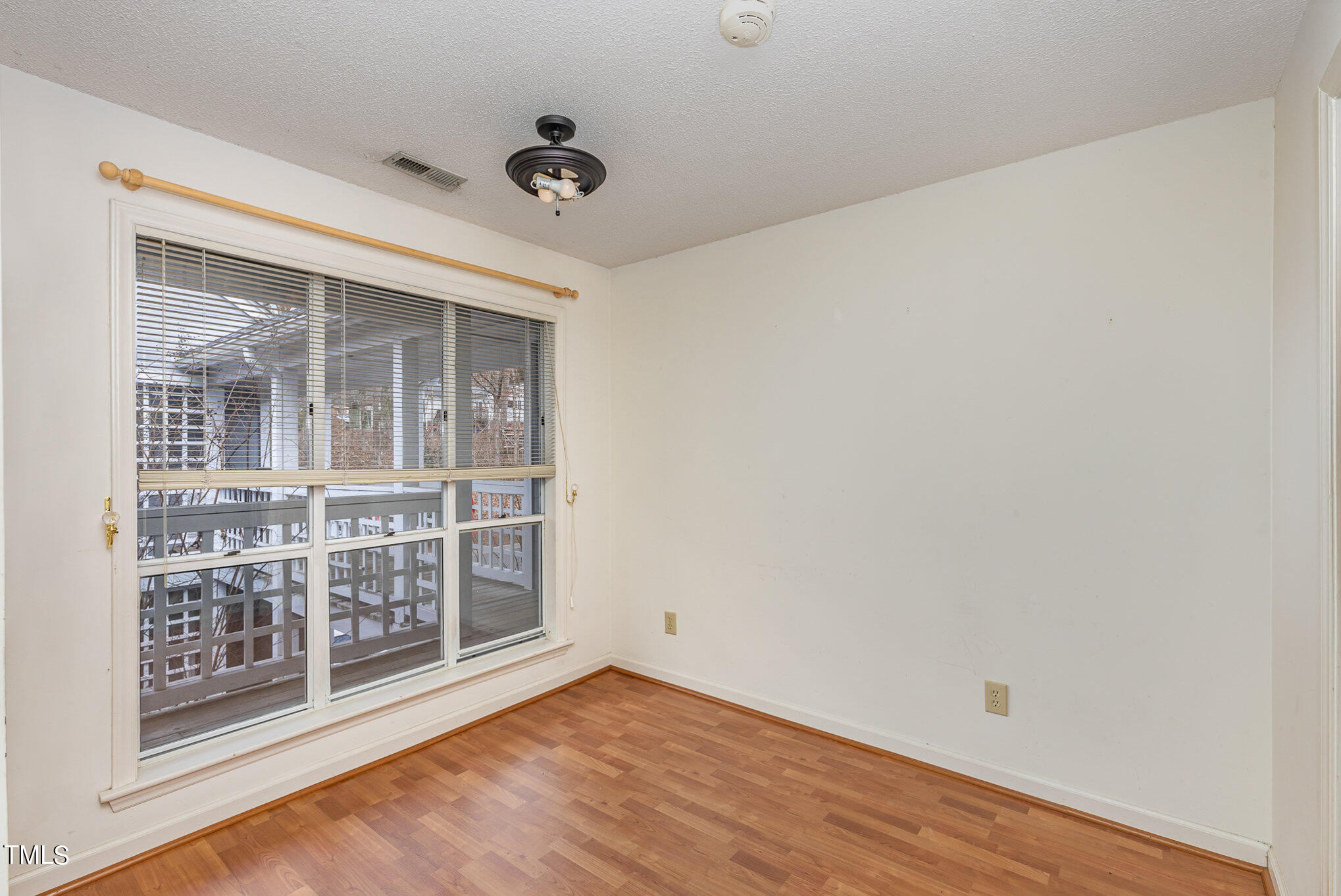 4631 Timbermill Court, Unit 303 Raleigh, NC 27612 - Photo 6 of 15 an empty room with wooden floor and windows