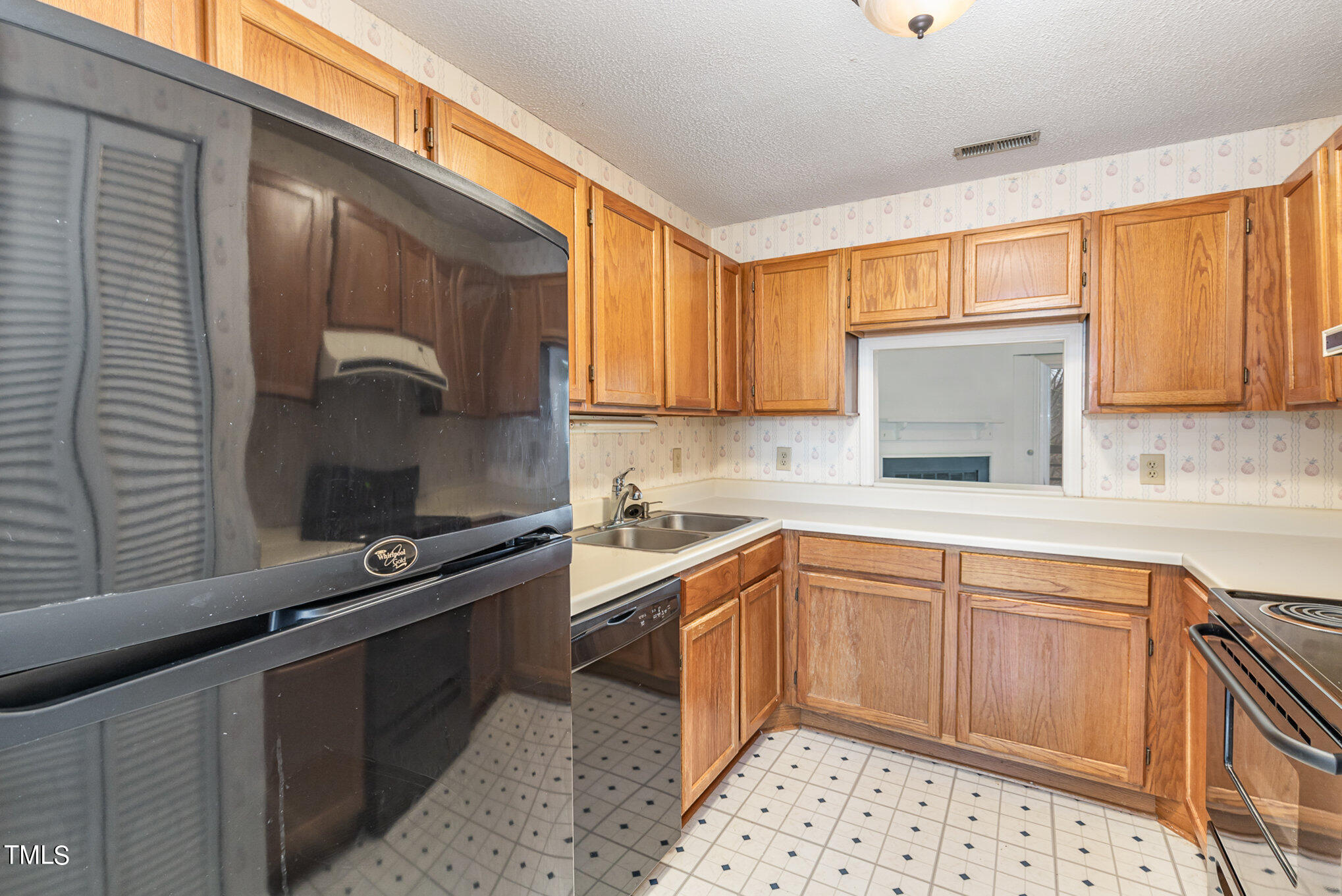 4631 Timbermill Court, Unit 303 Raleigh, NC 27612 - Photo 7 of 15 a kitchen with stainless steel appliances a sink stove and cabinets