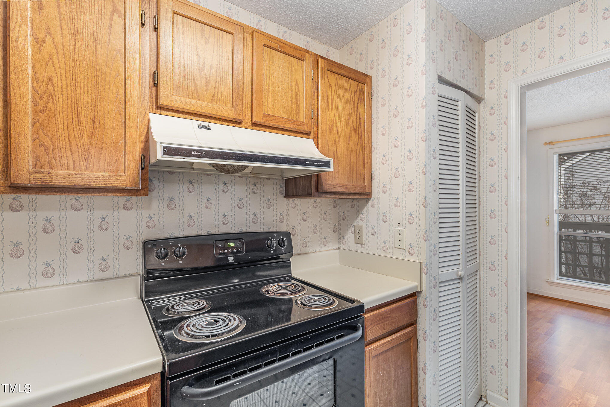 4631 Timbermill Court, Unit 303 Raleigh, NC 27612 - Photo 8 of 15 a kitchen with a stove and a microwave