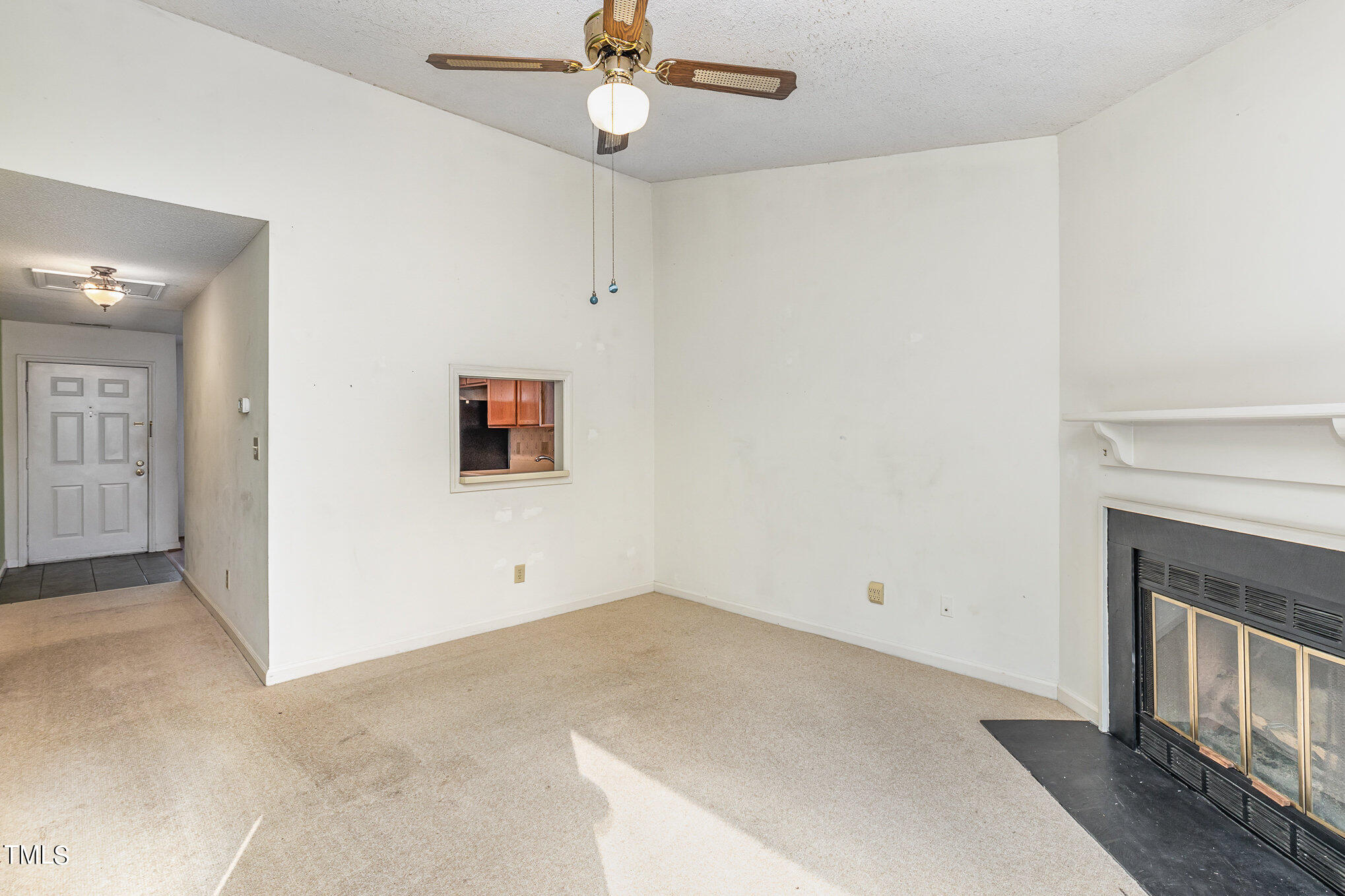 4631 Timbermill Court, Unit 303 Raleigh, NC 27612 - Photo 9 of 15 en empty room with ceiling fan and window