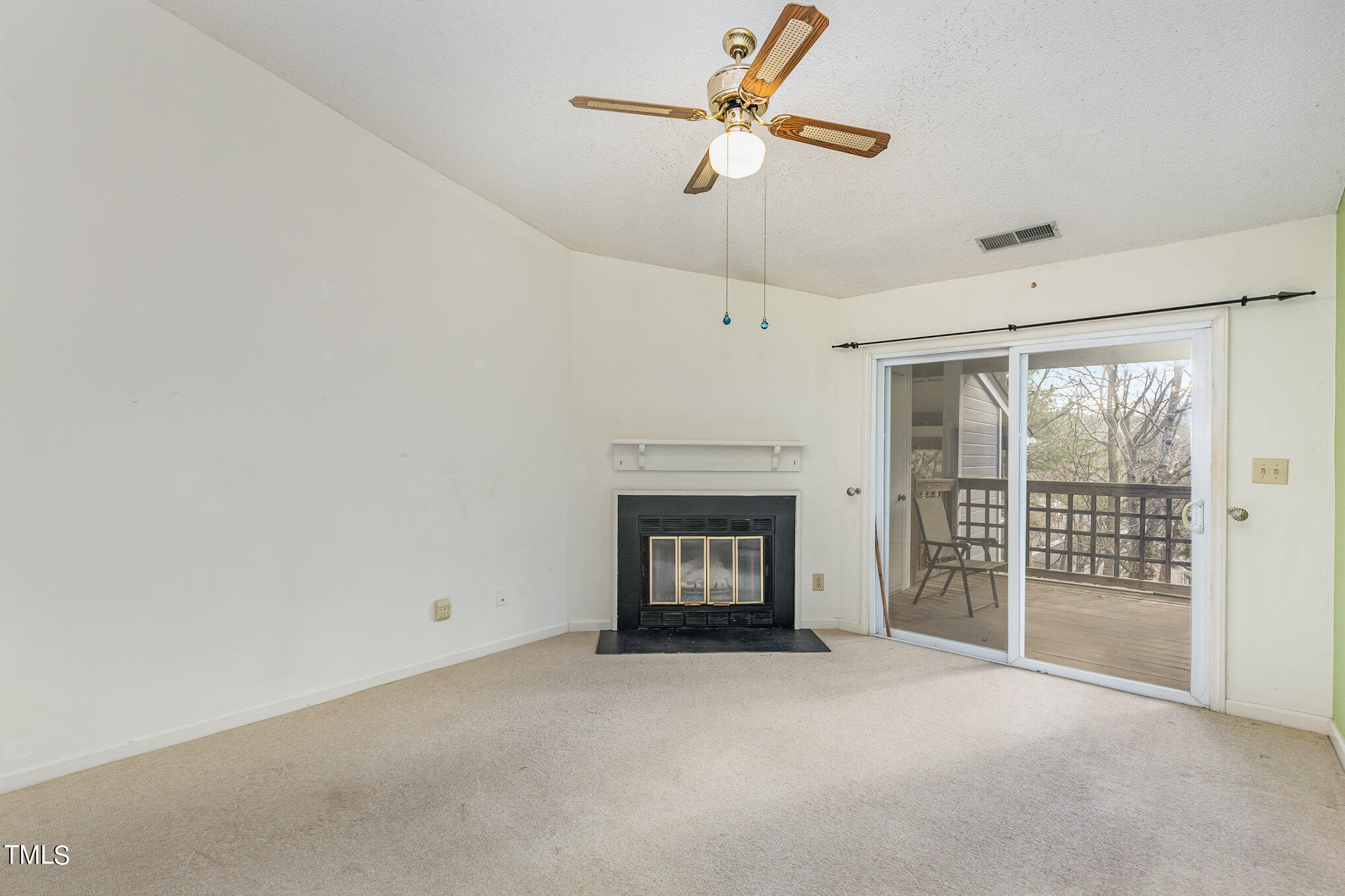 4631 Timbermill Court, Unit 303 Raleigh, NC 27612 - Photo 10 of 15 an empty room with fireplace and windows