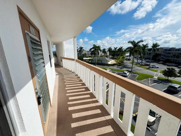 a view of balcony with wooden floor and fence