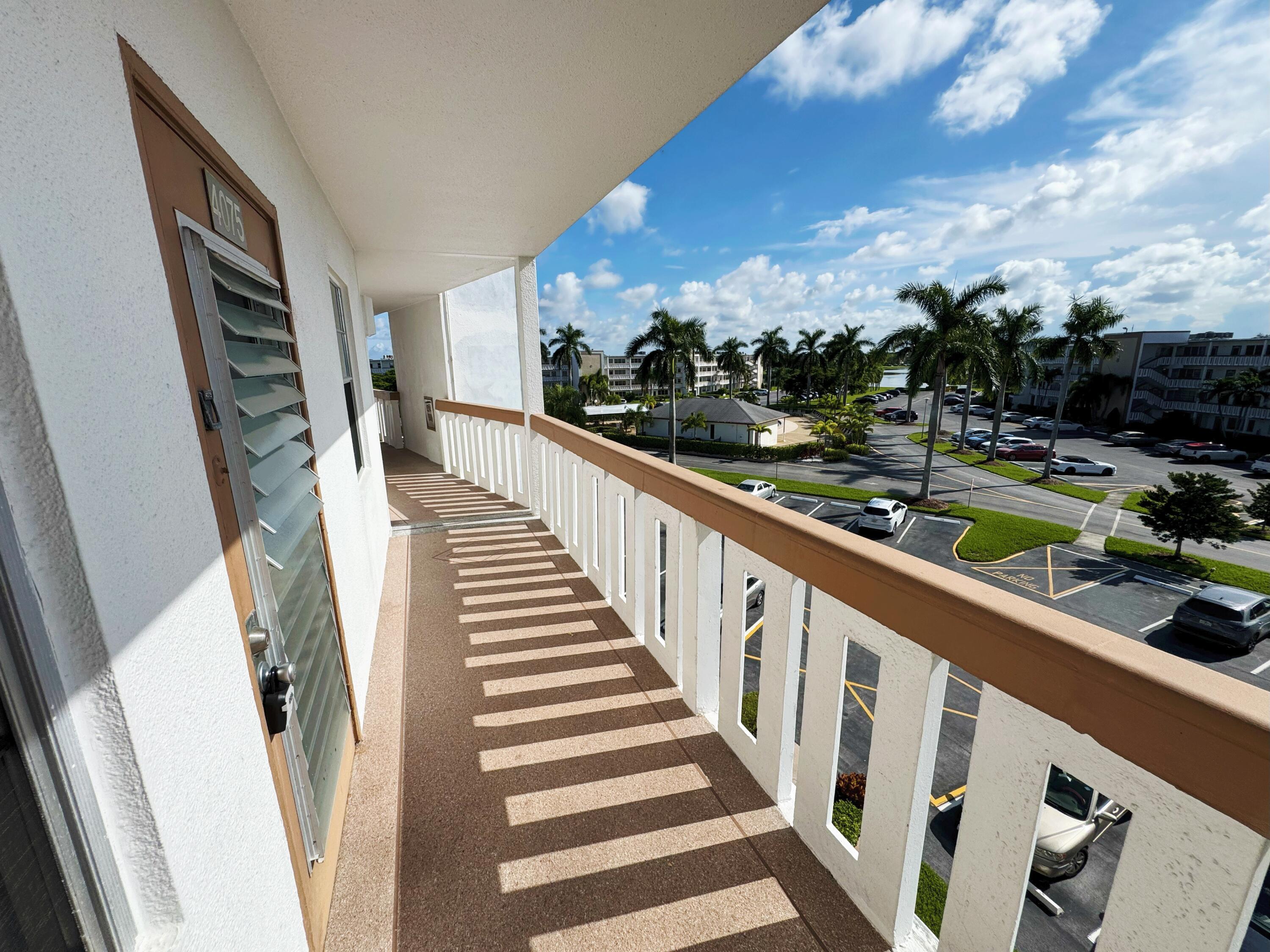 4075 Cornwall East Boca Raton, FL 33434 - Photo 1 of 30 a view of balcony with wooden floor and fence