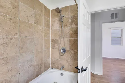 a bathroom with a shower and a toilet sink